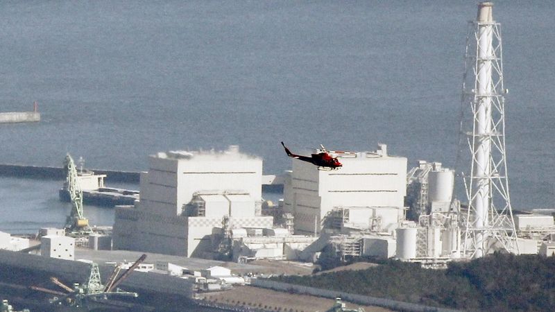 Nad elektrárnou Fukušima 1, která po zemětřesení vyzařuje vyšší radioaktivitu a ozval se z ní výbuch, přelétává vrtulník.