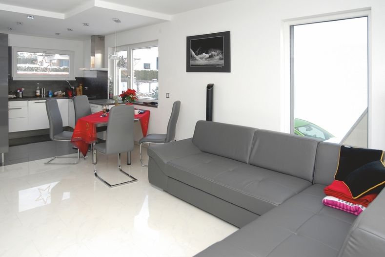 Obývací pokoj je spojený s kuchyní podél celé šíře domu. Jednou z dekorací je fotoakt, autorem je zpěvák Peter Nagy. 