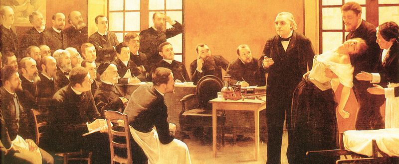 Jean-Martin Charcot demonstruje při své přednášce hypnózu na hysteričce Blanche Wittmanové (obraz Andrého Brouilleta, 1887).