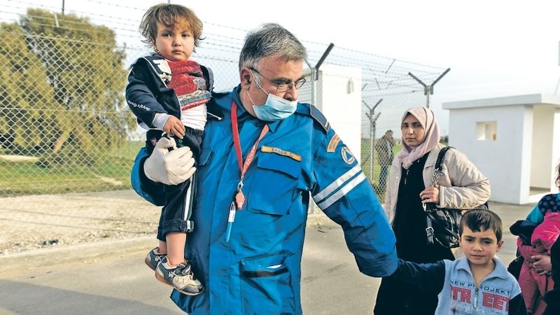 Humanitární pracovník doprovází část syrské rodiny do uprchlického tábora Kokkonotrimithia na Kypru. 