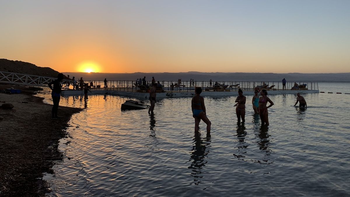 Turisté pobývají v léčivé vodě Mrtvého moře až do soumraku. Pokud budete mít na těle sebemenší ranku, rychle ji pocítíte.