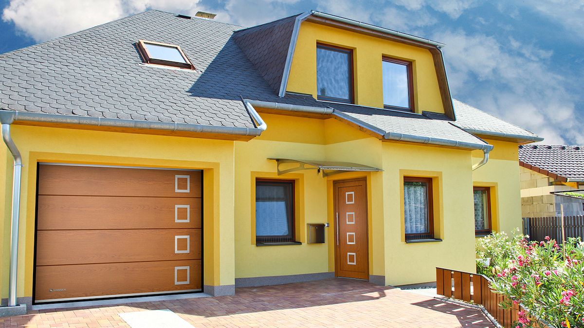 Vchodové dveře lze dokonale sladit s garážovými vraty a podtrhnout tak celkový vzhled domu.