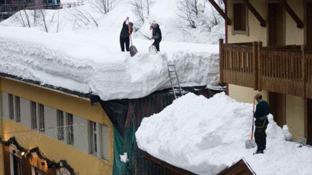 Odstraňování velkého množství sněhu z ploché střechy. Jak je to ale zde s bezpečností práce?