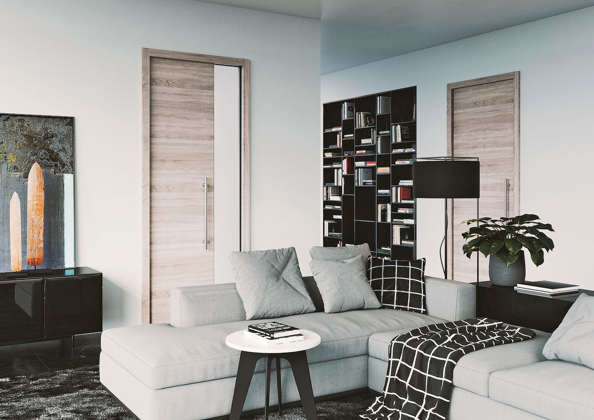 I v obývacím pokoji lze efektně využít prázdný výklenek, třeba knihovnou vyrobenou od truhláře.