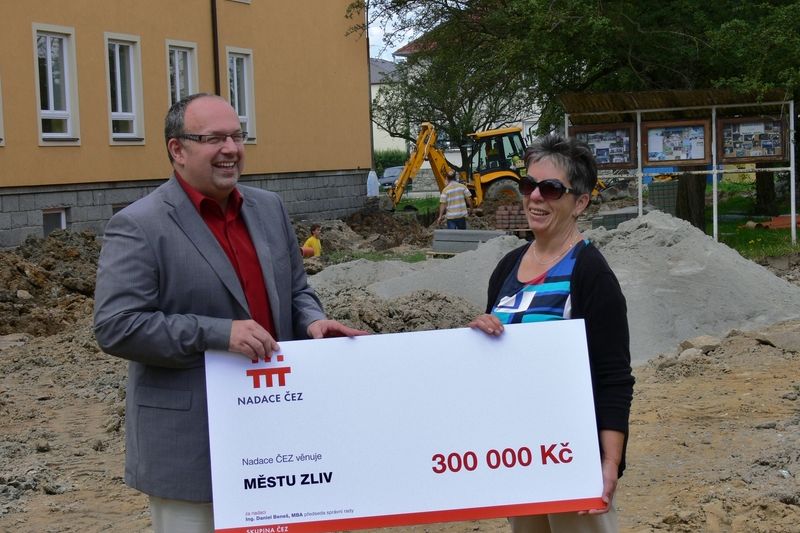 Ředitel Nadace ČEZ Ondřej Šuch předává zástupkyni Městského úřadu ve Zlivi Marii Čížkové symbolický šek na 300 tisíc korun.
