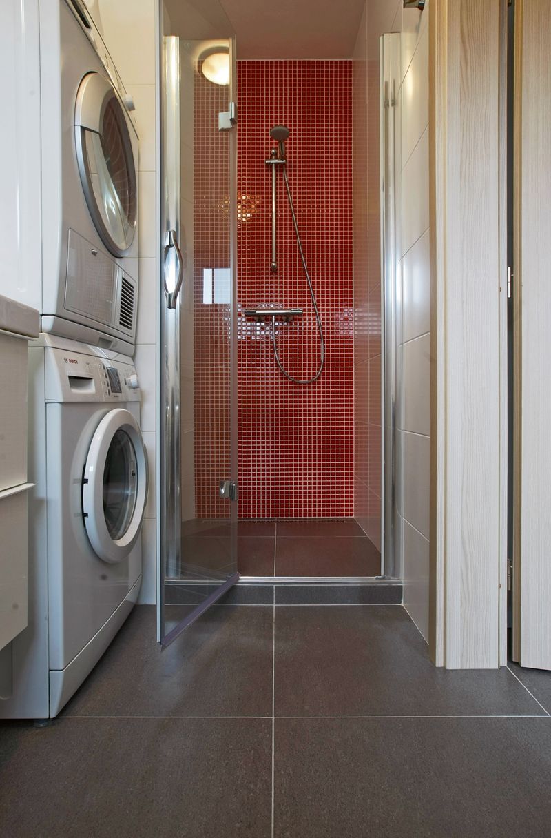 Také sprchový kout je obložen červenou mozaikou, což je nejen praktické, ale i zajímavé řešení.