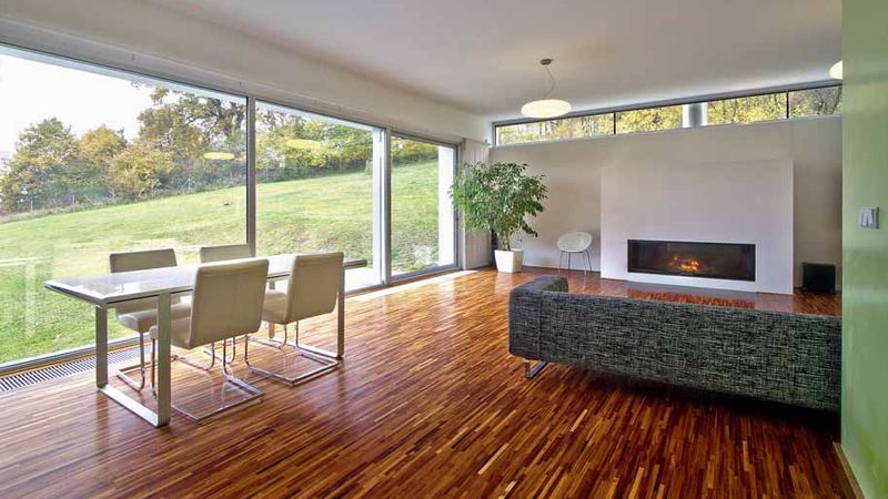 Obývací pokoj majitelé domu zařídili střídmě, hlavní roli hraje světlo a výhled ven. Přirozený dekor tvoří podlaha z olejovaného tropického dřeva. 