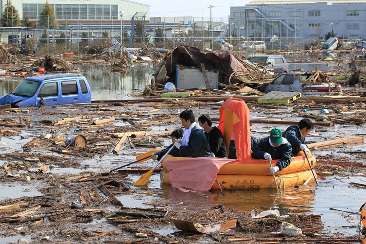 Japonci proplouvají na gumovém člunu mezi troskami města Sendaj