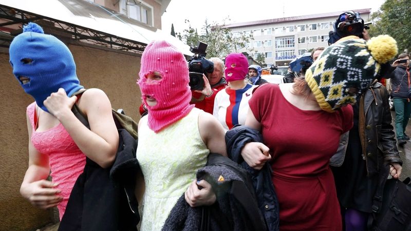 Maskované členky Pussy Riot opouštějí policejní stanici v Adleru u Soči. 