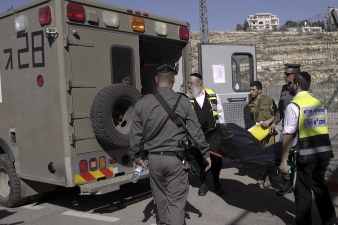 Izraelská záchranka nakládá tělo zastřeleného patnáctiletého Palestince Naíma Safího u kontrolního stanoviště u Jeruzeláma. Mladík běžel s nožem v ruce proti izraelské milici a ta ho zastřelila. 