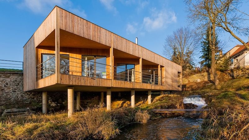 Dům nad vodopádem je dřevostavba vyzdvižená na betonových sloupech nad okolní terén.