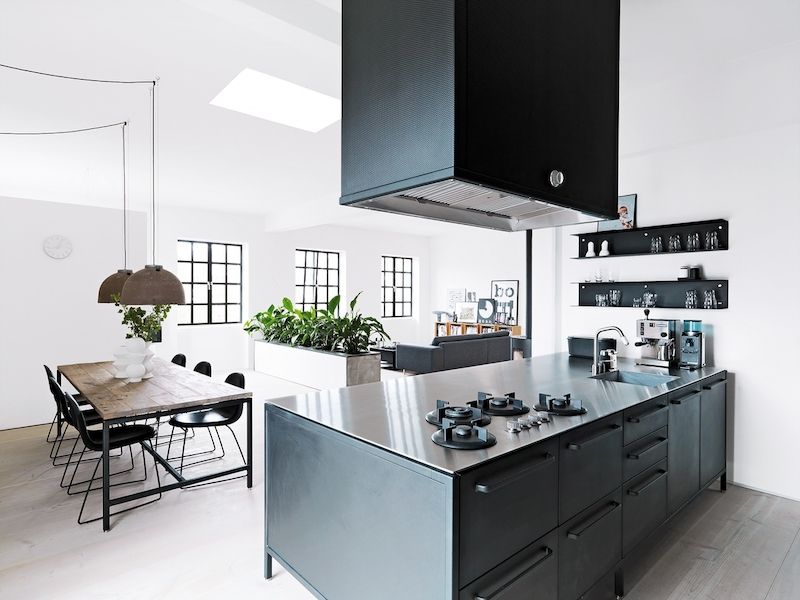 Středobodem kodaňského bytu je kuchyň z ocelových, černě práškovaných modulů, jimž vévodí pracovní deska z nerezavějící oceli. 