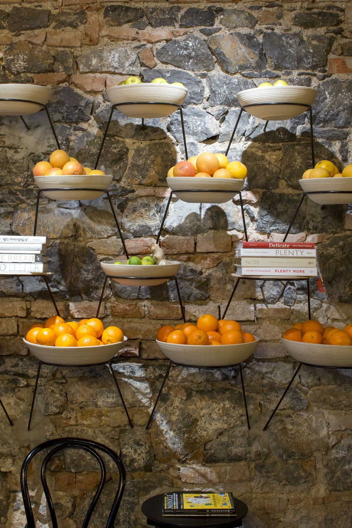 Nevšední výzdobou stěn jsou kovové držák s terakotovými mísami naplněnými čerstvým ovocem.