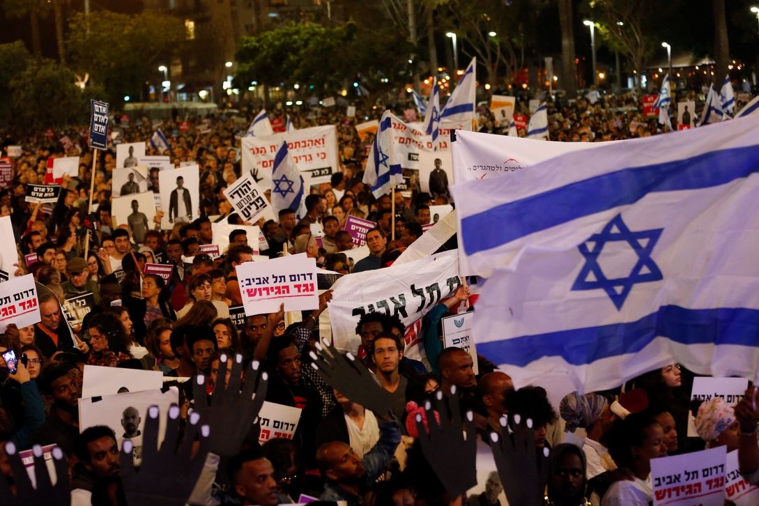 Tisíce lidí protestují v Tel Avivu proti vládnímu plánu na deportaci migrantů z Afriky.