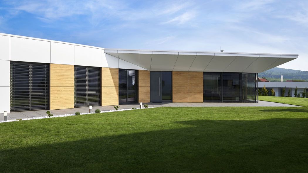 Čistý geometrický tvar domu je zvýrazněn fasádou kombinovanou z elementárních ploch skla, dřevěných desek a HPL laminátu.