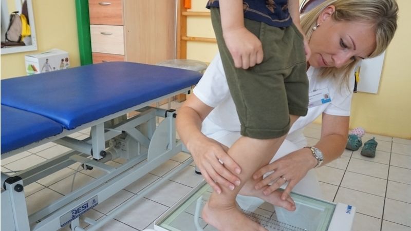 Fyzioterapeutka Polikliniky AGEL v Olomouci Mgr. Šárka Halfarová vyšetřuje dětského pacienta.