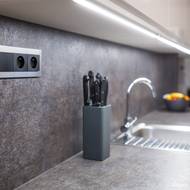 Trojrámeček pro zásuvky a vypínač hezky kombinuje nerez s matnou černou barvou.