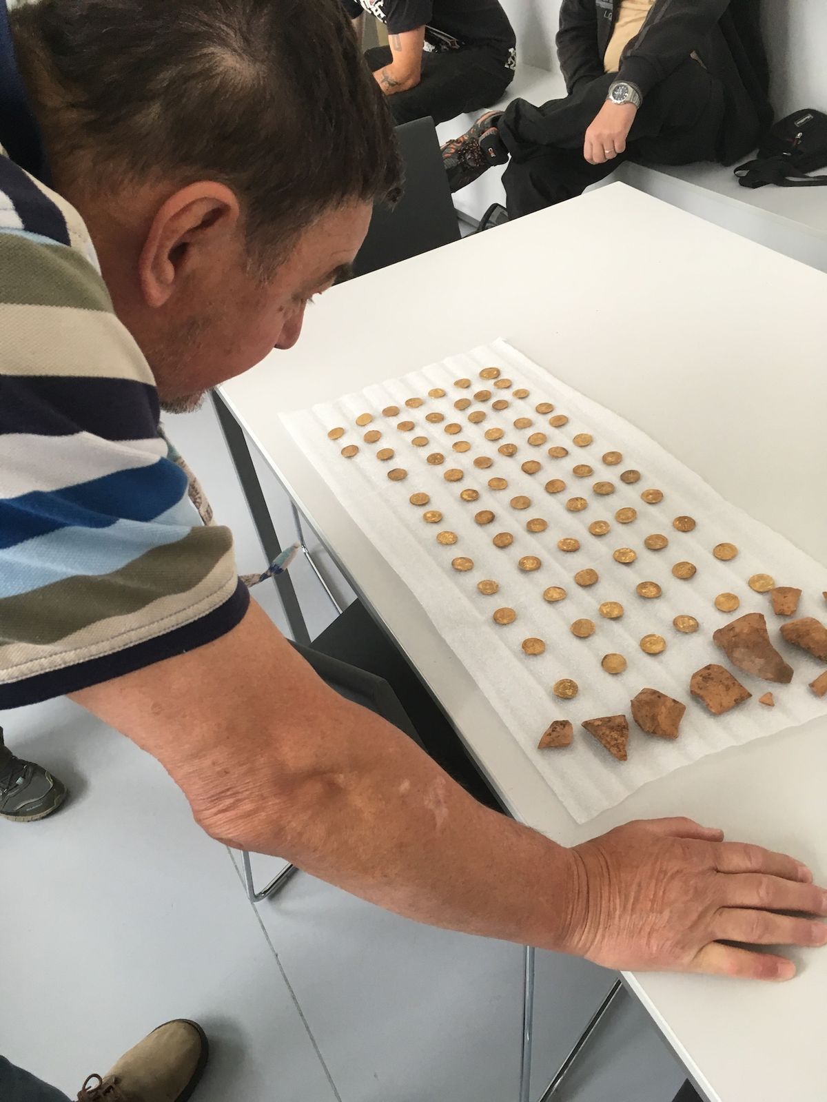 Ředitel muzea Pavel Hrubec si prohlíží objevené zlaté mince.