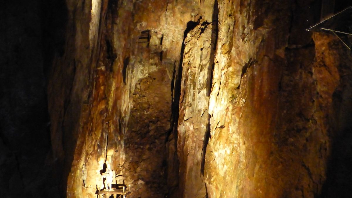Důlní prací vznikl i tento monumentální podzemní sál. Dole dotváří atmosféru figurína horníka v životní velikosti.
