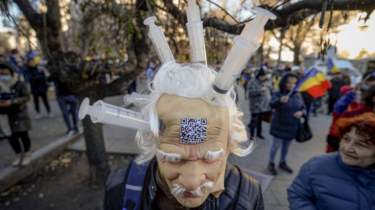 Muž v masce na demonstraci v Bukurešti