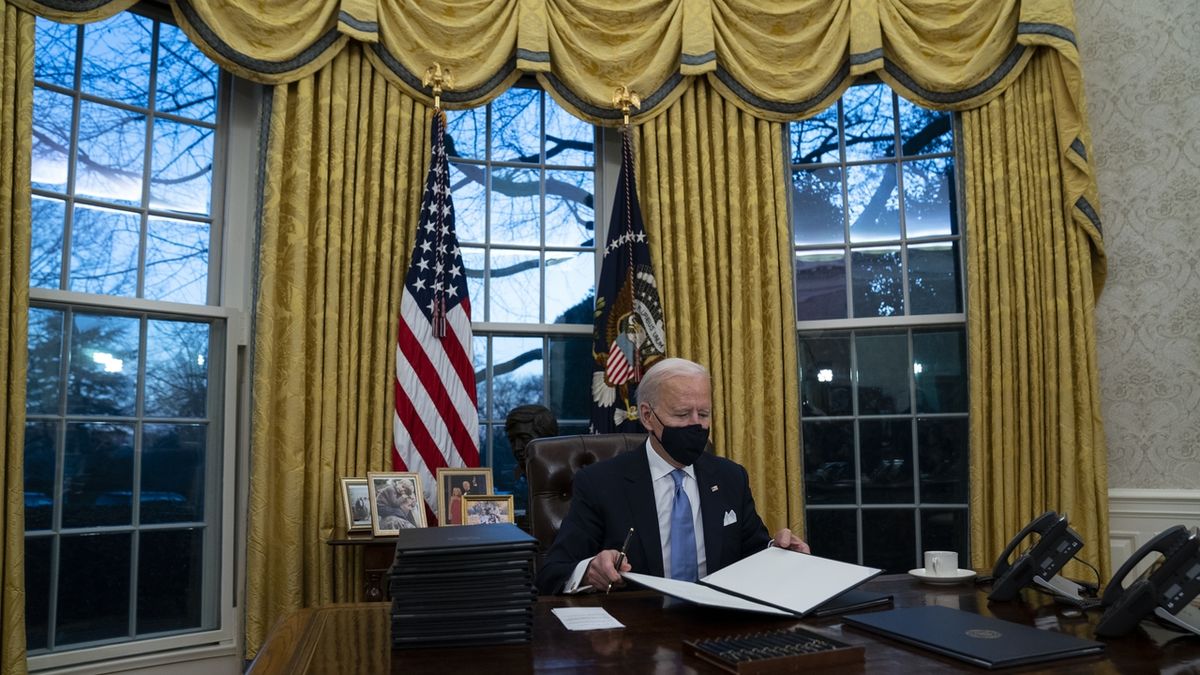 Joe Biden v Oválné pracovně podepisuje exekutivní příkazy. 