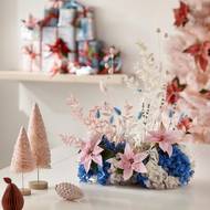 Aranžmá z čerstvých řezaných vánočních hvězd, sušených travin a listů a barvených hortenzií působí optimisticky a stylově. 