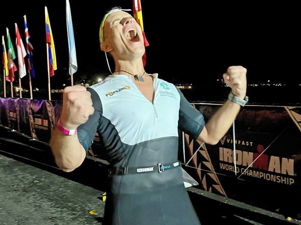 Triathlete celebrating after finishing the Ironman in Hawaii