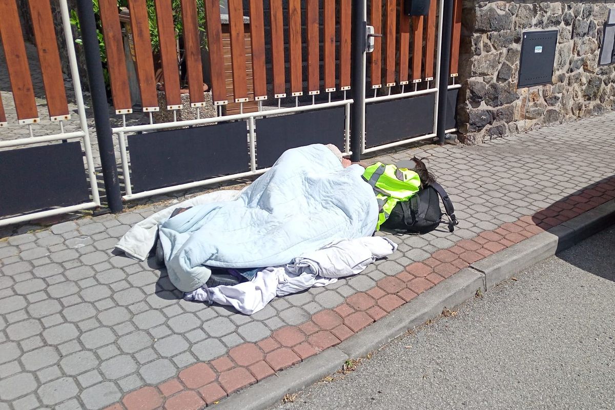 Bezdomovci si ustlali na chodníku v Táboře. Pod sebe si dali prostěradlo a přikryli se dekou