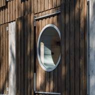 Dřevěná fasáda ladí s okolím. 