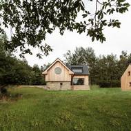 Stavbu krášlí kulaté okno, které působí jako velmi střídmý dekorativní prvek.