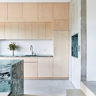 Skřínky kuchyně jsou z březové překližky, která funguje jako klidné pozadí pro výrazný kuchyňský ostrůvek.