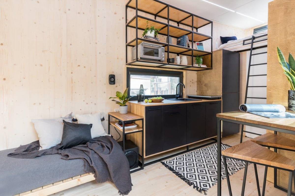 Interiér je rozdělen na tři hlavní zóny – obývací, kuchyňskou a jídelní, a koupelnu s loftem.