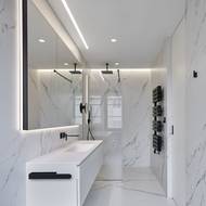 Zvolené povrchy dodávají koupelnám punc luxusu.