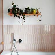 Klidnou, nenápadnou estetiku koupelny vkusně oživují květiny.