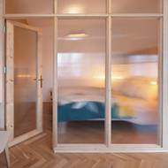 Prosklená stěna odděluje spací část od zbytku prostoru, aniž by ztratila denní světlo.