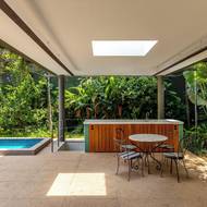 Prostor u bazénu doplňuje venkovní kuchyně.