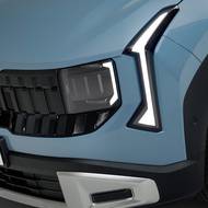 Přídi dominuje tmavá maska v kombinaci se štíhlými světly denního svícení a šikovně skrytými hlavními světlomety.